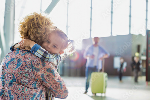 Bild auf Leinwand Portrait of woman reuniting with her daughter in airport