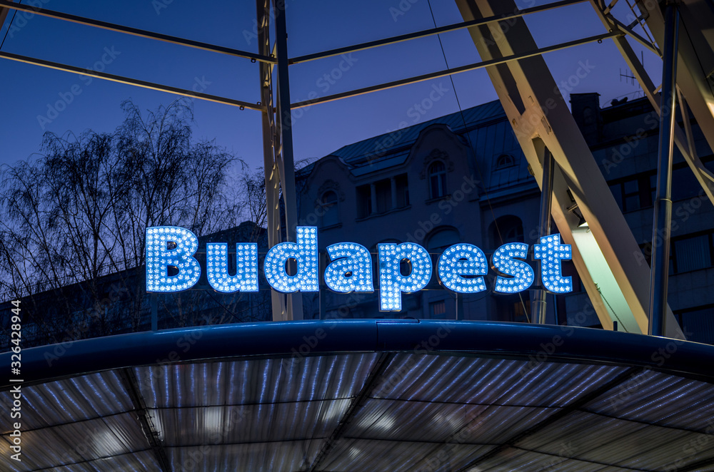 Fototapeta premium Budapest sign at blue hour on Budapest Eye ferris wheel