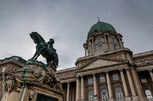 statue and building on Buda Castle Hill on a rainy winter day