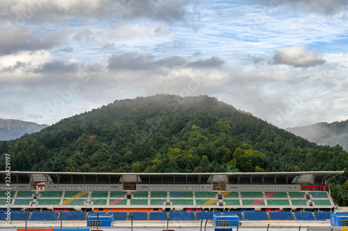 Stadium seats in the racetrack with fog on mountain