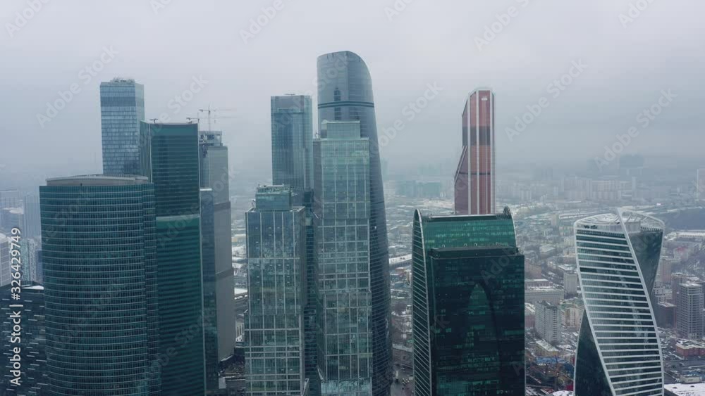 Aerial drone shot flying over center of Moscow city buildings, skyscrapers at cloudy winter day. Drone shot flying over Moscow skyscrapers. Aerial drone shot flying over center of Moscow city buildings, skyscrapers at cloudy winter day. Drone shot flying over Moscow skyscrapers.