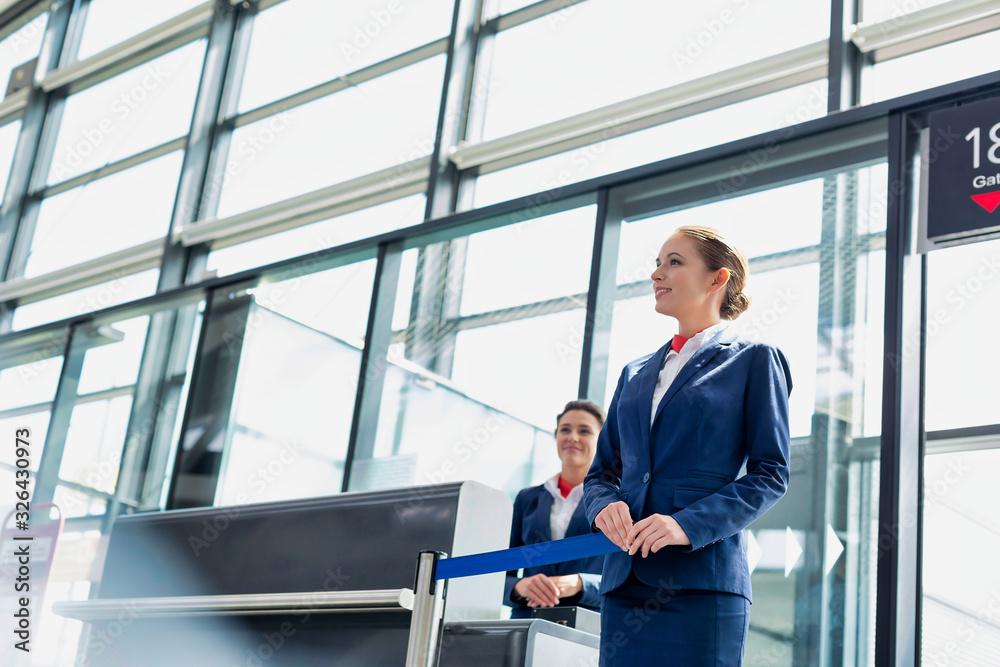 Portrait of young beautiful airport staff opening the gate for boarding in airport Portrait of young beautiful airport staff opening the gate for boarding in airport