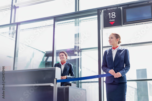 Photography Portrait of young beautiful airport staff opening the gate for boarding in airpo