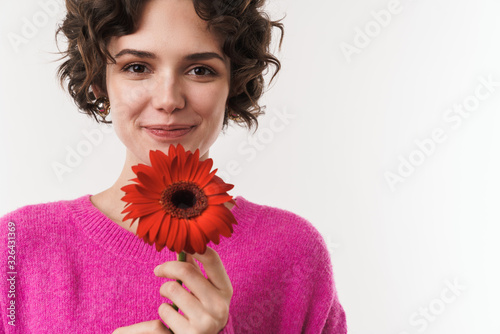 Принти на полотні Image of cheerful beautiful woman smiling and holding flower