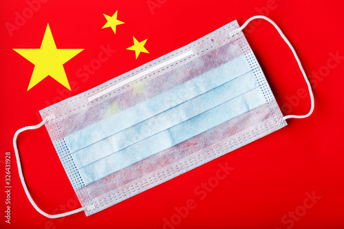 Medical mask on the background of the Chinese flag. Disposable face masks for viruses, Coro novirus. photo