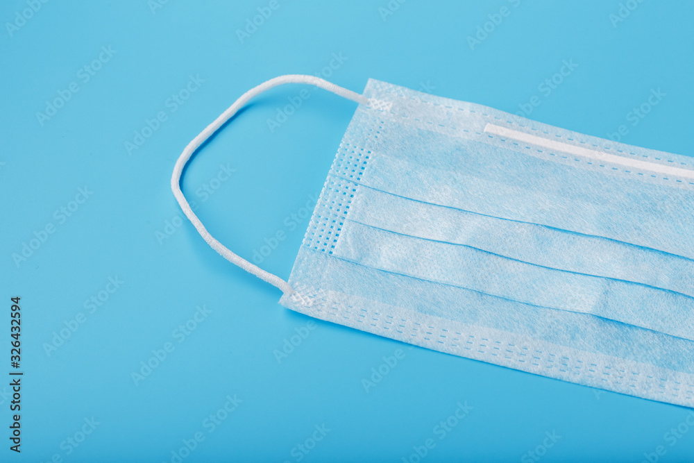 Medical mask on a blue background. Disposable face masks for viruses. Free space. Medical mask on a blue background. Disposable face masks for viruses. Free space.