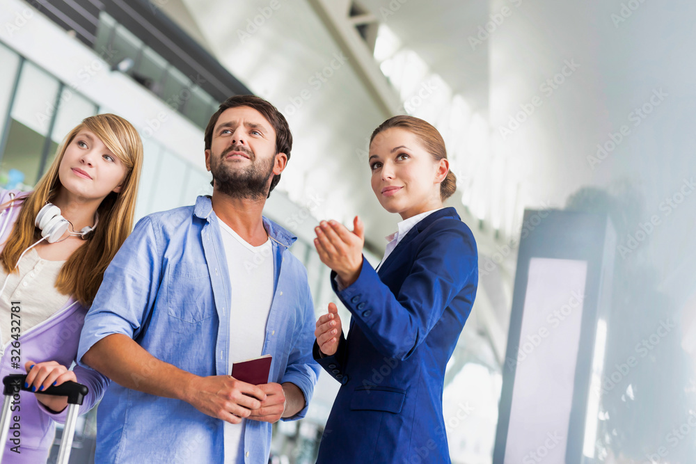 Mature man traveling with her sister while asking for assistance with the airport staff Mature man traveling with her sister while asking for assistance with the airport staff