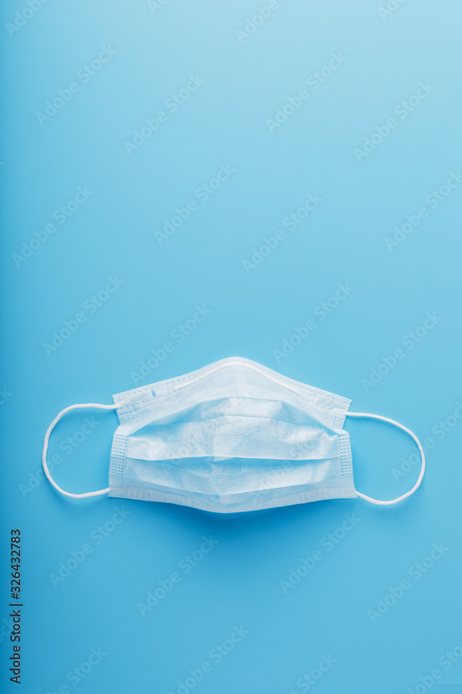 Medical mask on a blue background. Disposable face masks for viruses. Free space. Medical mask on a blue background. Disposable face masks for viruses. Free space.