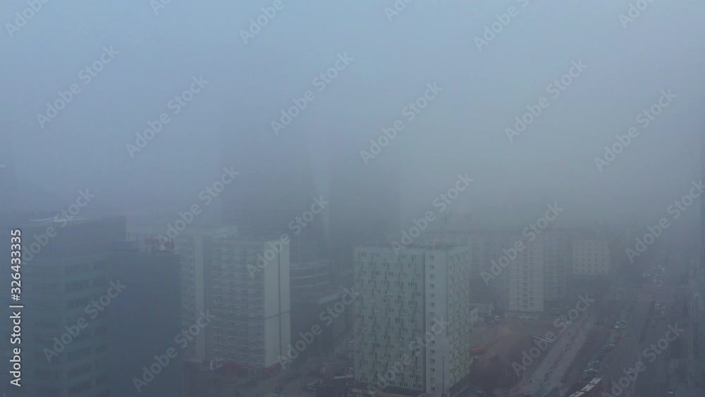 Aerial view of skyscrapers, buildings and traffic covered in clouds of smog in Warsaw city center Aerial view of skyscrapers, buildings and traffic covered in clouds of smog in Warsaw city center