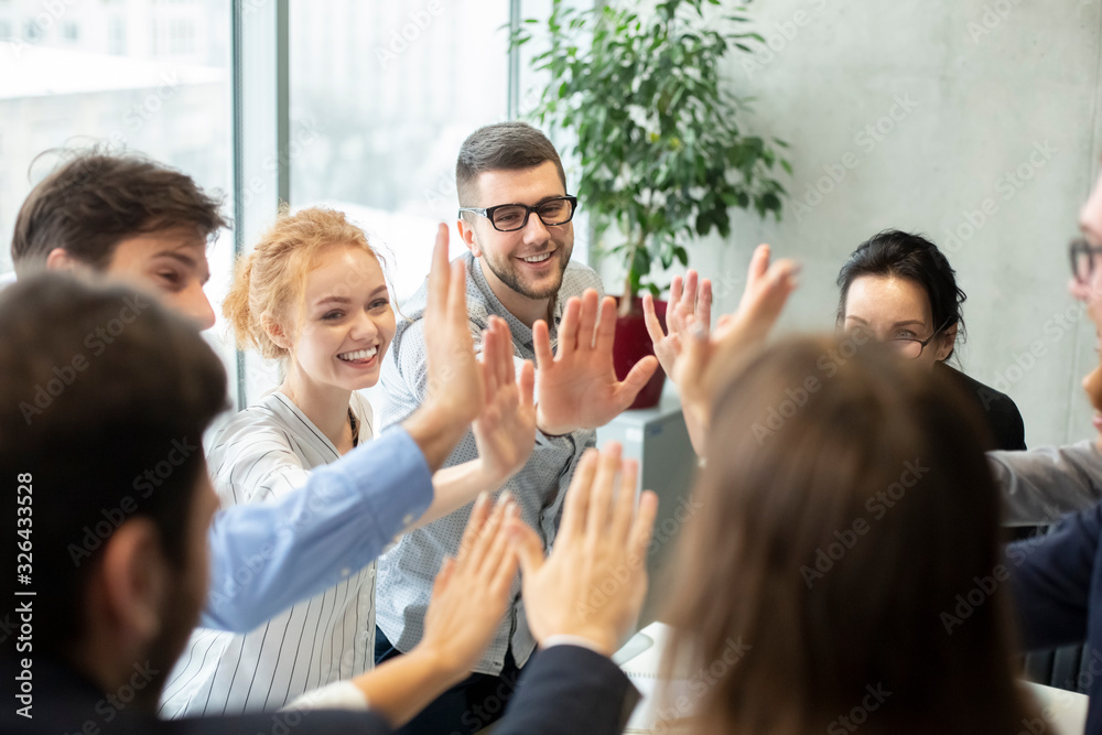 Obraz premium Team inspiration concept. Colleagues giving high five