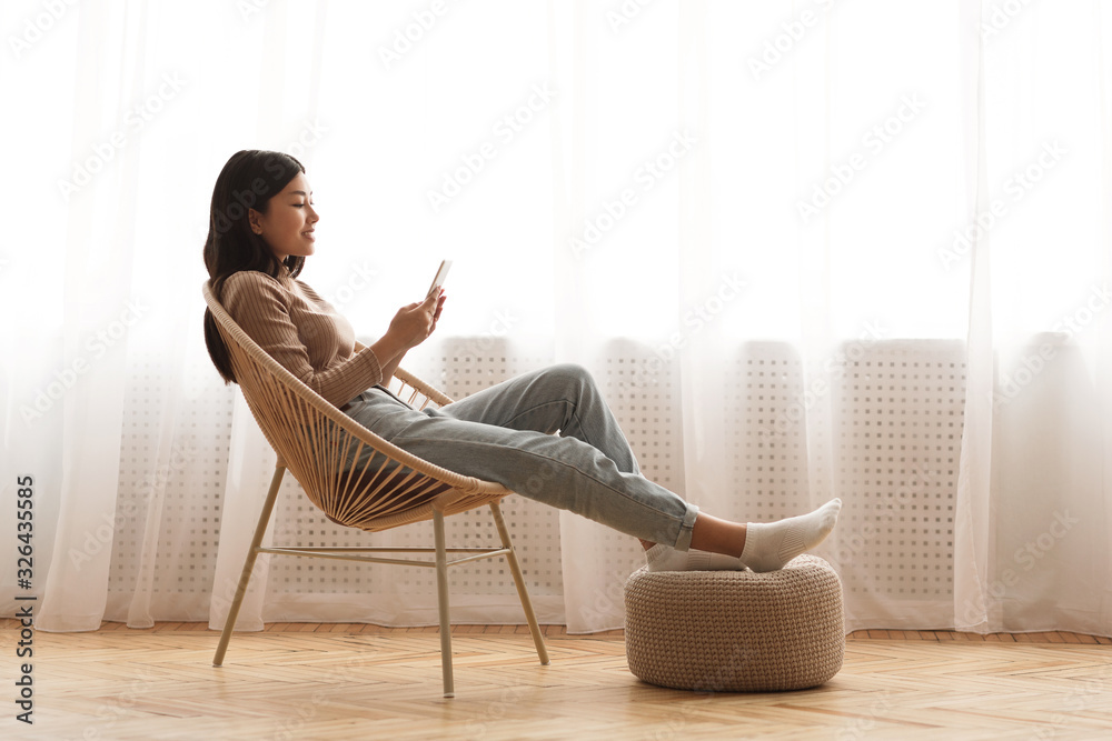 Time to relax. Calm girl networking on smartphone - obrazy, fototapety, plakaty 