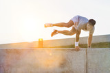 Young attractive man jumping on wall