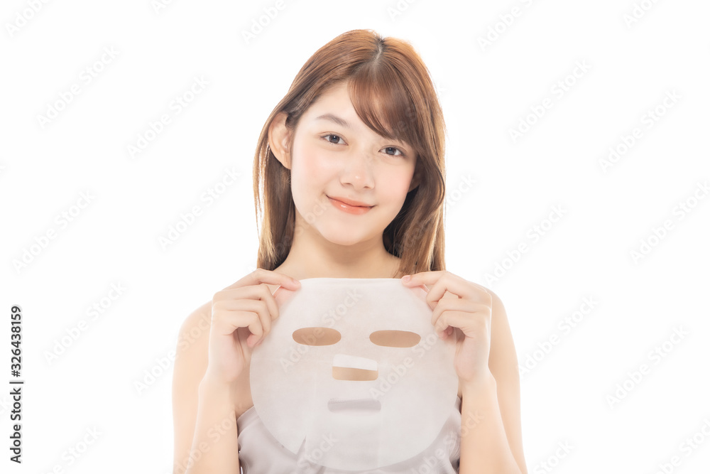 Young Asian girl with facial mask looking at camera over white background. Cosmetic procedure. Beauty spa and cosmetology. Young Asian girl with facial mask looking at camera over white background. Cosmetic procedure. Beauty spa and cosmetology.