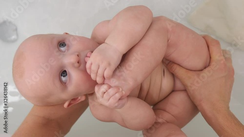 Funny Baby Sucking Her Fingers On Leg While Bathing. 