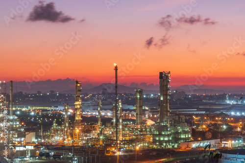 Petrochemical Industrial.. Oil refinery factory and oil storage tank at twilight and night.