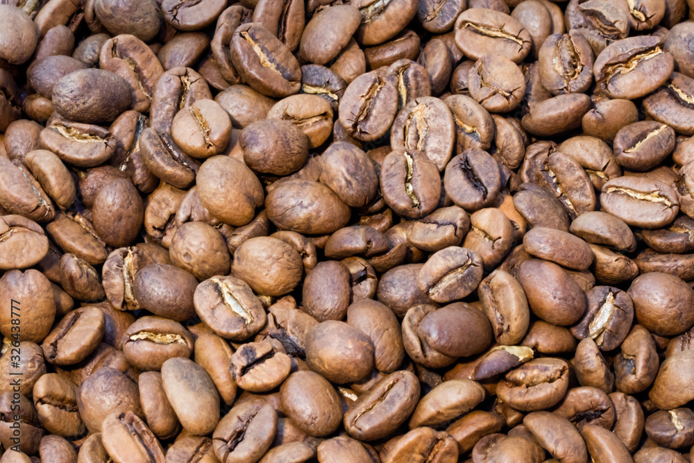 Texture of brown roasted coffee beans pile Texture of brown roasted coffee beans pile
