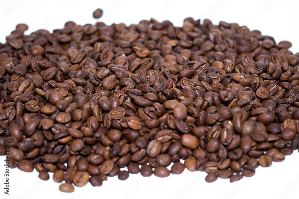 Roasted coffee beans pile isolated on white background. Selective focus.