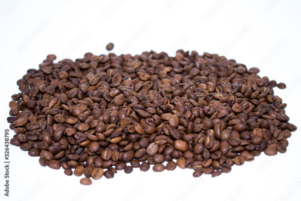 Roasted coffee beans pile isolated on white background. Selective focus. Roasted coffee beans pile isolated on white background. Selective focus.