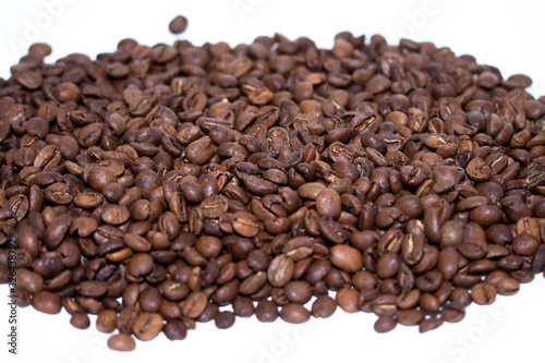 Roasted coffee beans pile isolated on white background. Selective focus.