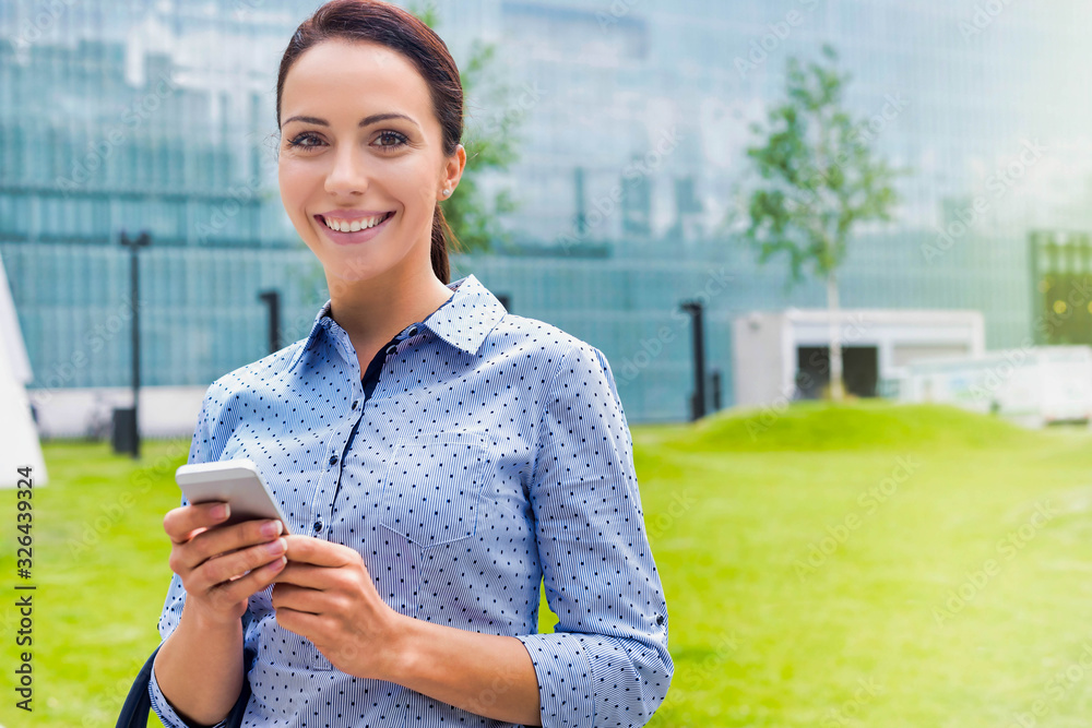 Young attractive businesswoman using smartphone outdoors Young attractive businesswoman using smartphone outdoors
