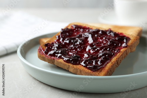 Delicious crispy toasts with jam on table, closeup