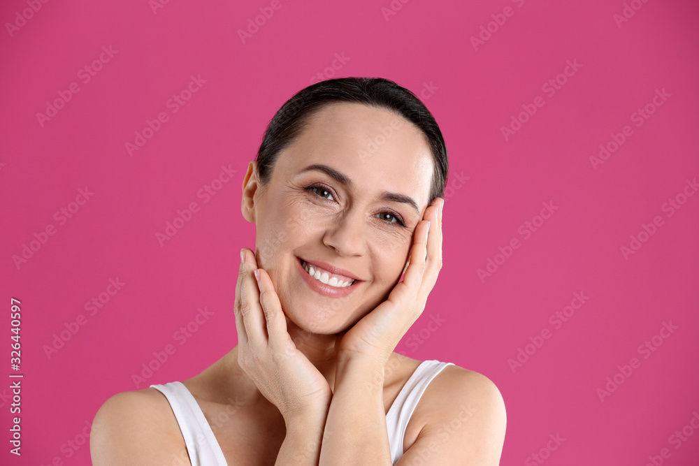 Portrait of beautiful mature woman on pink background Portrait of beautiful mature woman on pink background