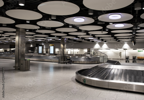 Fototapeta Naklejka Na Ścianę i Meble -  Empty baggage carousel conveyor at the baggage collection hall in Terminal, Heathrow Airport, London. Heathrow is the main airport serving London.