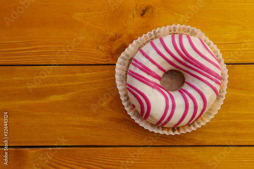 Tasty donut on wooden background