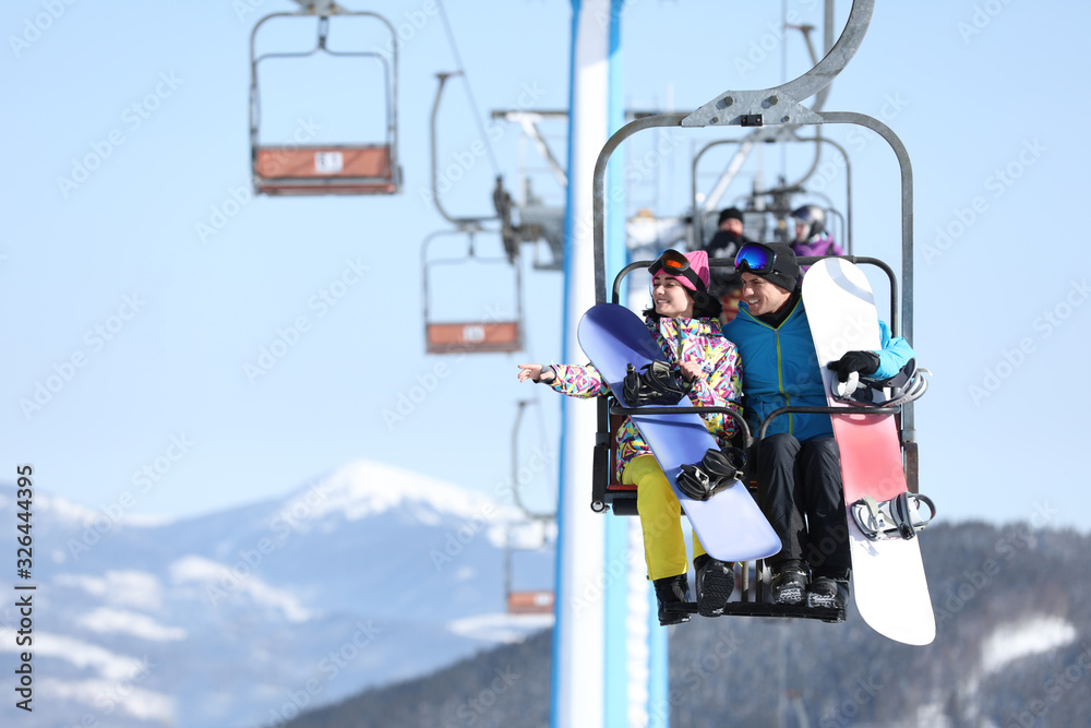 People using chairlift at mountain ski resort, space for text. Winter vacation People using chairlift at mountain ski resort, space for text. Winter vacation