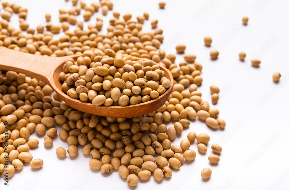 Soybeans on wooden spoon and scattered on white background Soybeans on wooden spoon and scattered on white background
