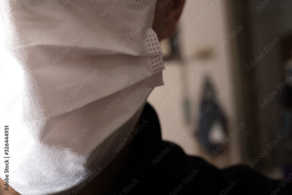 Obraz premium Closeup with the face of a young man wearing medical or surgical mask