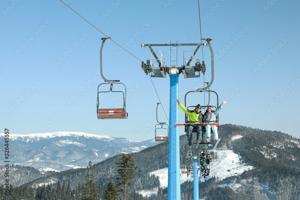 People using chairlift at mountain ski resort. Winter vacation People using chairlift at mountain ski resort. Winter vacation