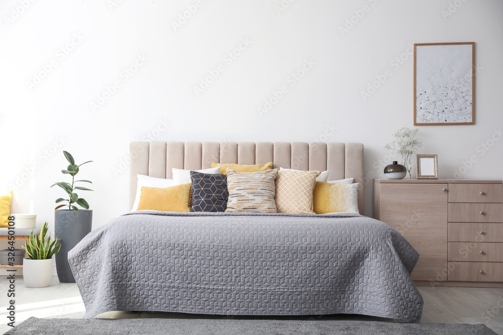Stylish interior of contemporary room with comfortable bed Stylish interior of contemporary room with comfortable bed
