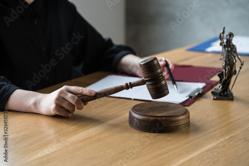 Wallpaper Mural justice and law concept. Female judge in a courtroom on wooden table and Counselor or Male lawyer working in office. Legal law, advice and justice concept. Torontodigital.ca