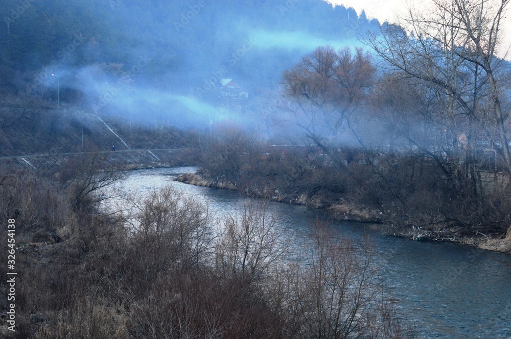 a cloud of smoke above the river