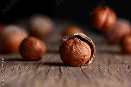 hazelnut in a shell close-up on a textured wooden background photo