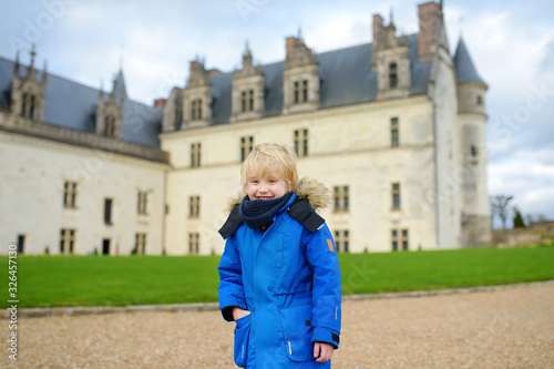 Little boy on the background of famous Royal chateau in Amboise. photo