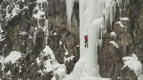 Amazing aerial lone climber scaling ice cascade Maineline, Mount Kineo 4K photo