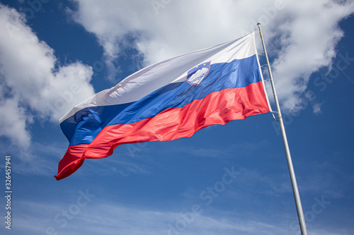 Slovenia flag on sky background. Eastern Europe