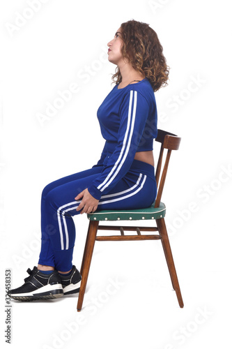 portrait of a woman sitting on a chair in white background,look up photo