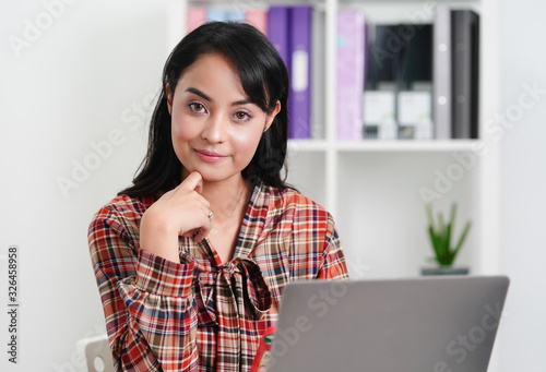 Asian  freelance businesswoman working in the office with happiness. confident girl is working in front of computer. 