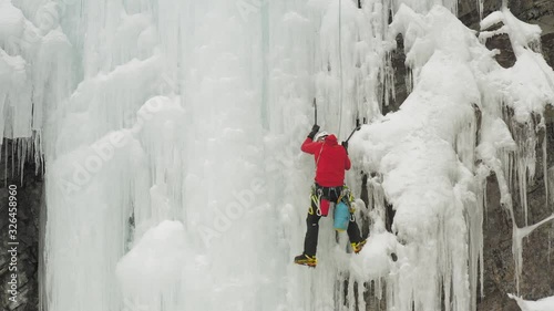 Climber scales huge ice cascade Maineline, Kineo Mountain 4K photo