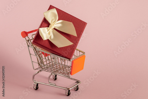 Gift in the shopping cart.  Selective focus.