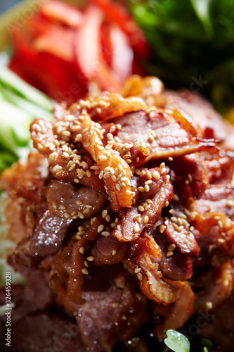 Korean grilled meat dish on plate with vegetable 