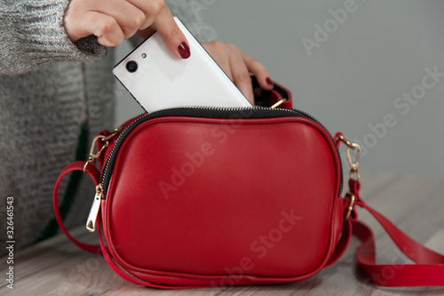 woman hand phone with bag pocket