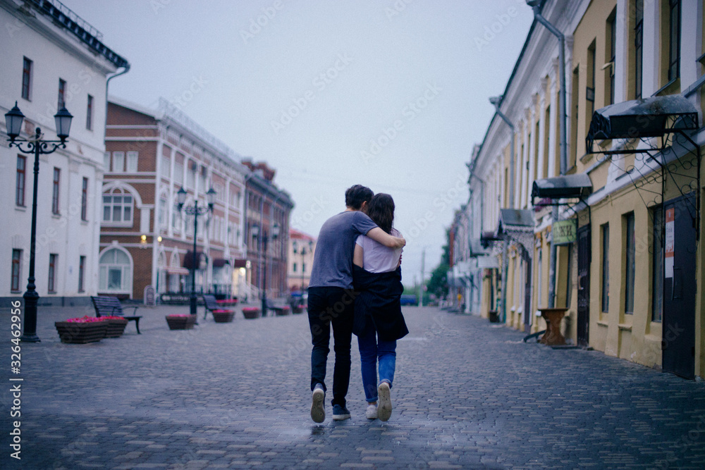 Hugging loving boy and girl outside