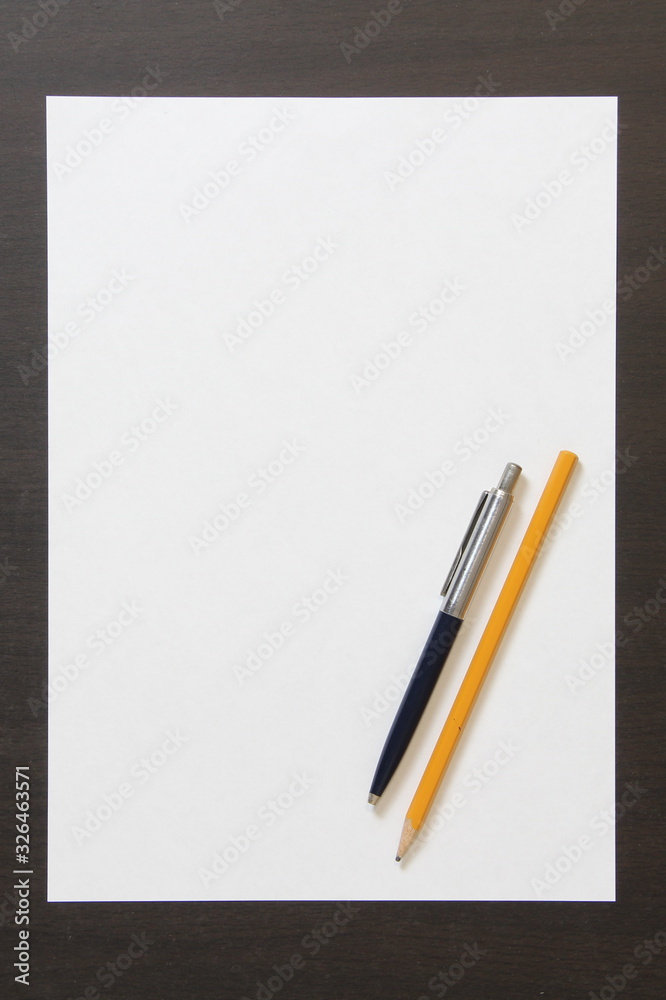 Template of white paper with pen and pencil on dark wenge color wooden background. Template of white paper with pen and pencil on dark wenge color wooden background.