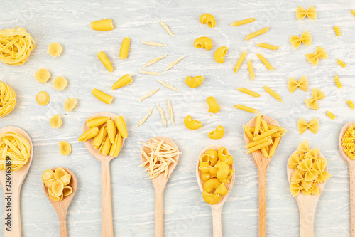 Flat lay with different types of traditional italian pasta. Penne, tagliatelle, fusilli, farfalle, spaghetti and others. Traditional italian cusine concept. Top view