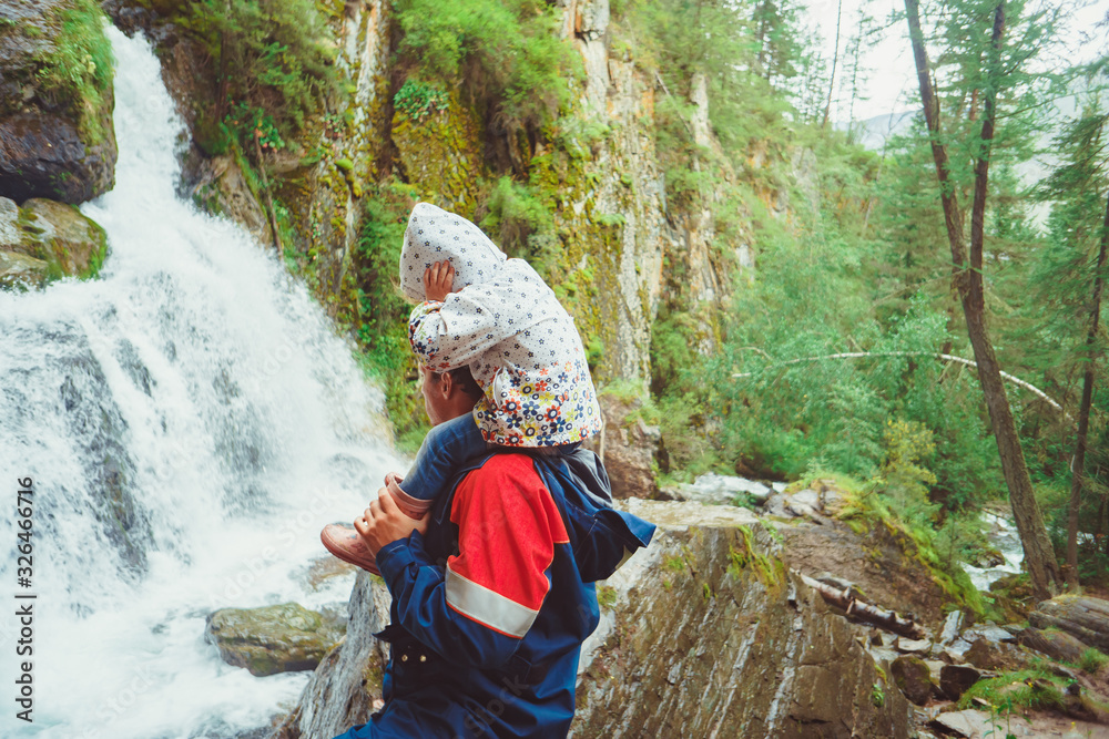 dad and daughter at the waterfall