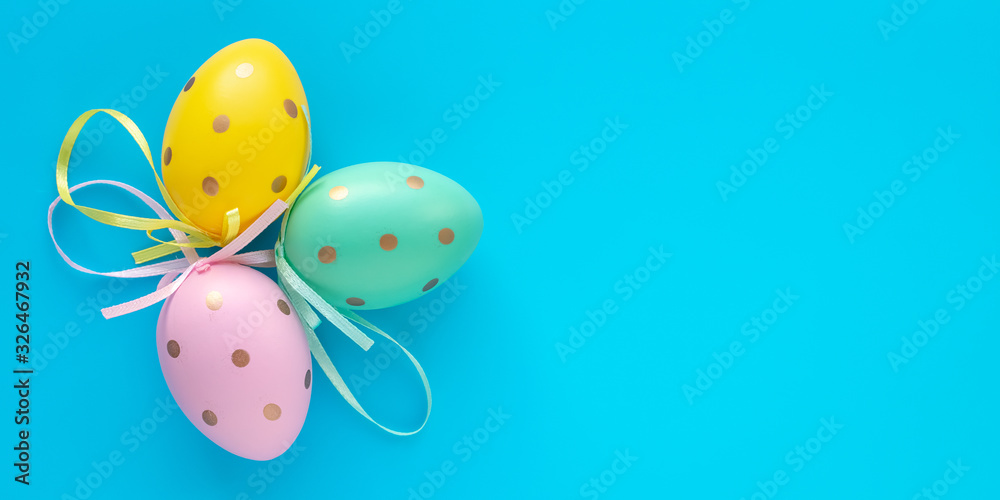 Easter eggs on turquoise background, paschal gift card with text space. Art design decoration. Colorful paschal egg, holiday pattern, mock-up.